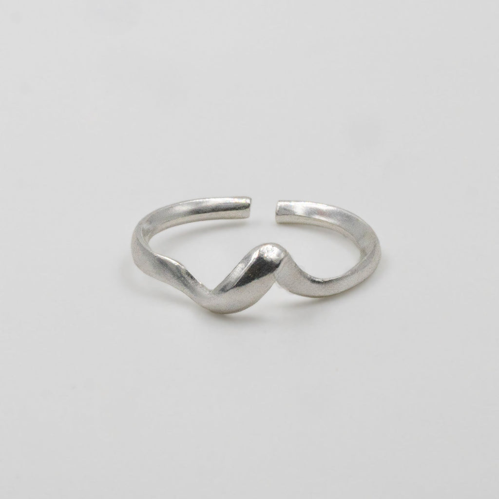 Silver ring on a light gray background