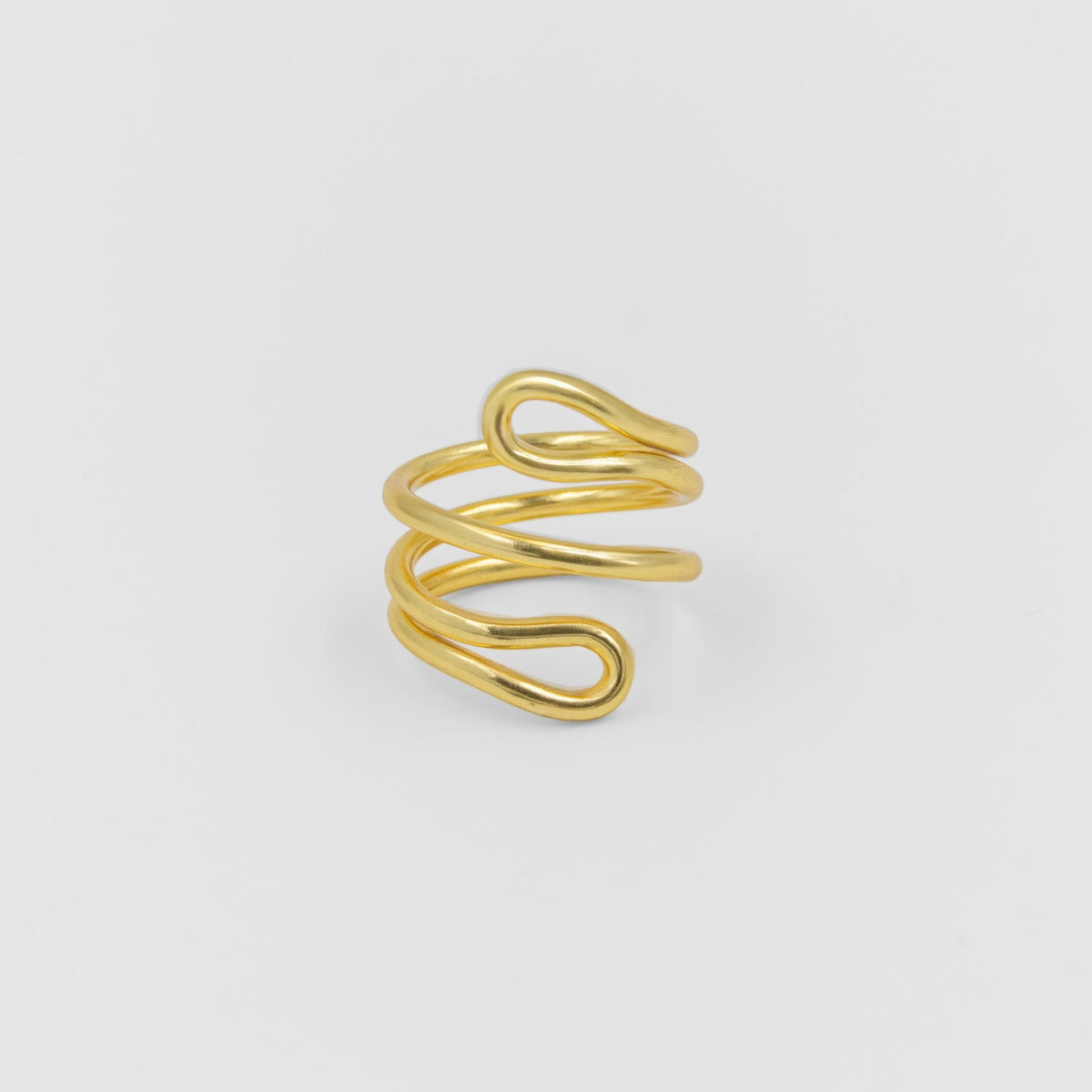 Gold spiral ring on a light gray background