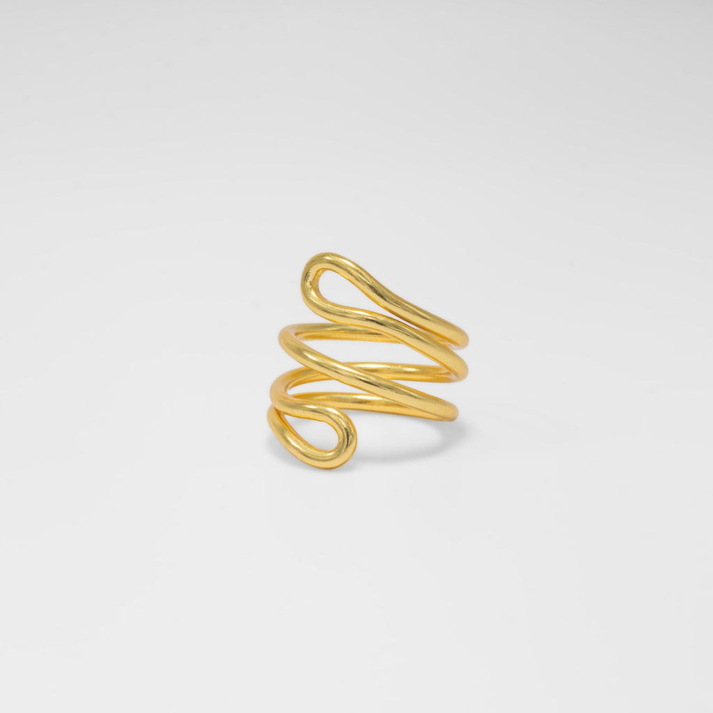 Gold spiral ring on a light gray background