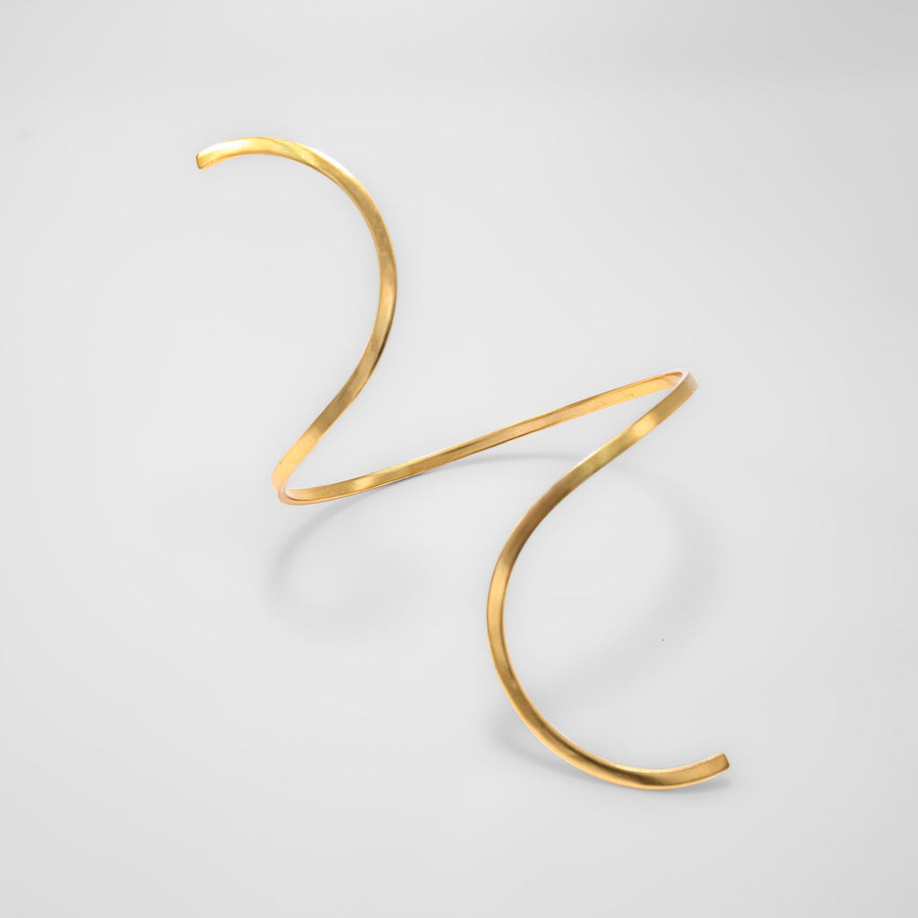 Gold anklet on a light gray background