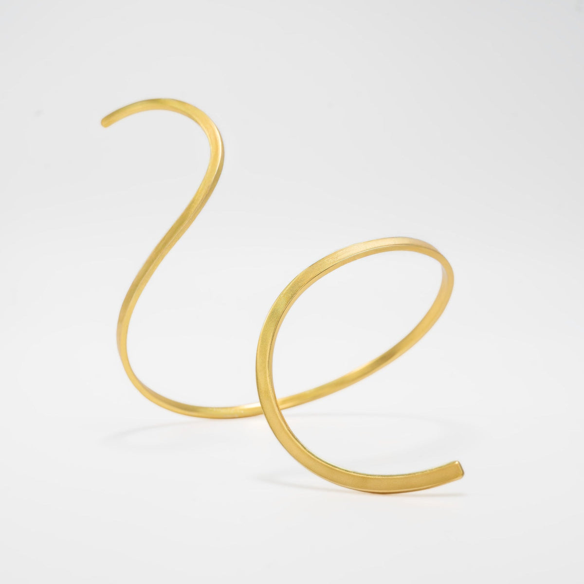 Gold anklet on a light gray background