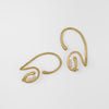 Gold earcuffs with pearls on a white background