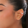 Gold ear cuff with pearl accent worn by a model