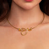 Gold necklace with a unique pendant design worn by a person