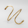 Gold spiral bracelet on a light gray background