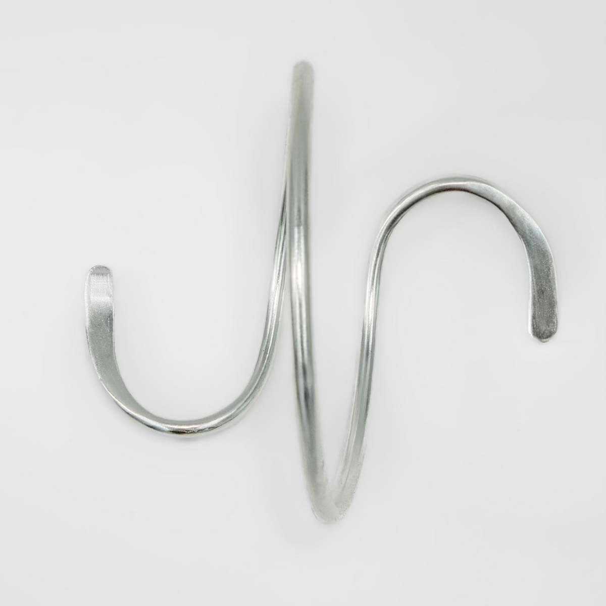 Metallic spiral hand cuff on a white background