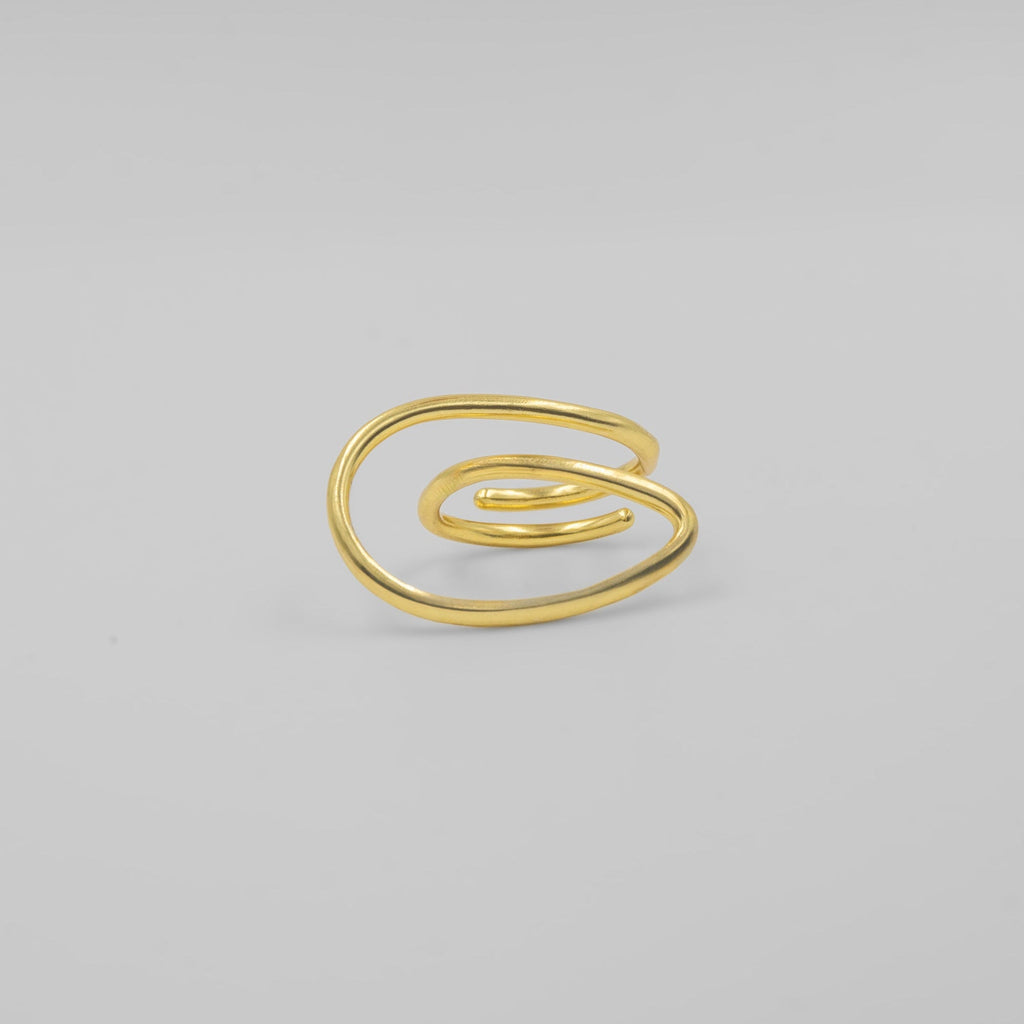 Gold spiral ring on a light gray background