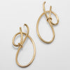 Gold hoop earrings on a light gray background