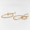 Gold hoop earrings on a white background