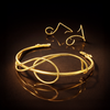 Gold choker and earcuffs on a reflective black surface