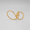 Gold ring on a light gray background