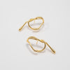 Pair of gold earrings on a light gray background