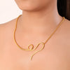 Gold necklace with a unique-shaped pendant on a model