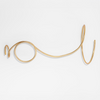 Gold wire hand cuff on a white background