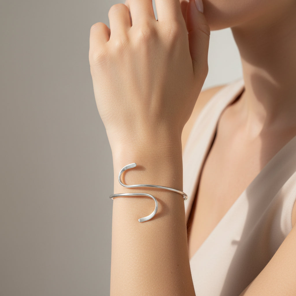 Silver twisted bracelet on a white background