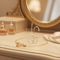 Gold and silver jewellery on a reflective surface with a dark background