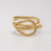 Gold ring with a modern design on a light gray background