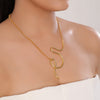 Gold necklace on a model with a plain background