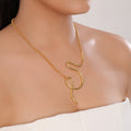Gold necklace on a model with a plain background