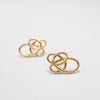 Pair of gold earrings on a light gray background