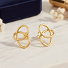 Pair of gold earrings on a light gray background