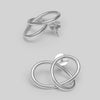 Pair of silver earrings on a light gray background