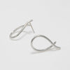 Pair of silver earrings on a light gray background