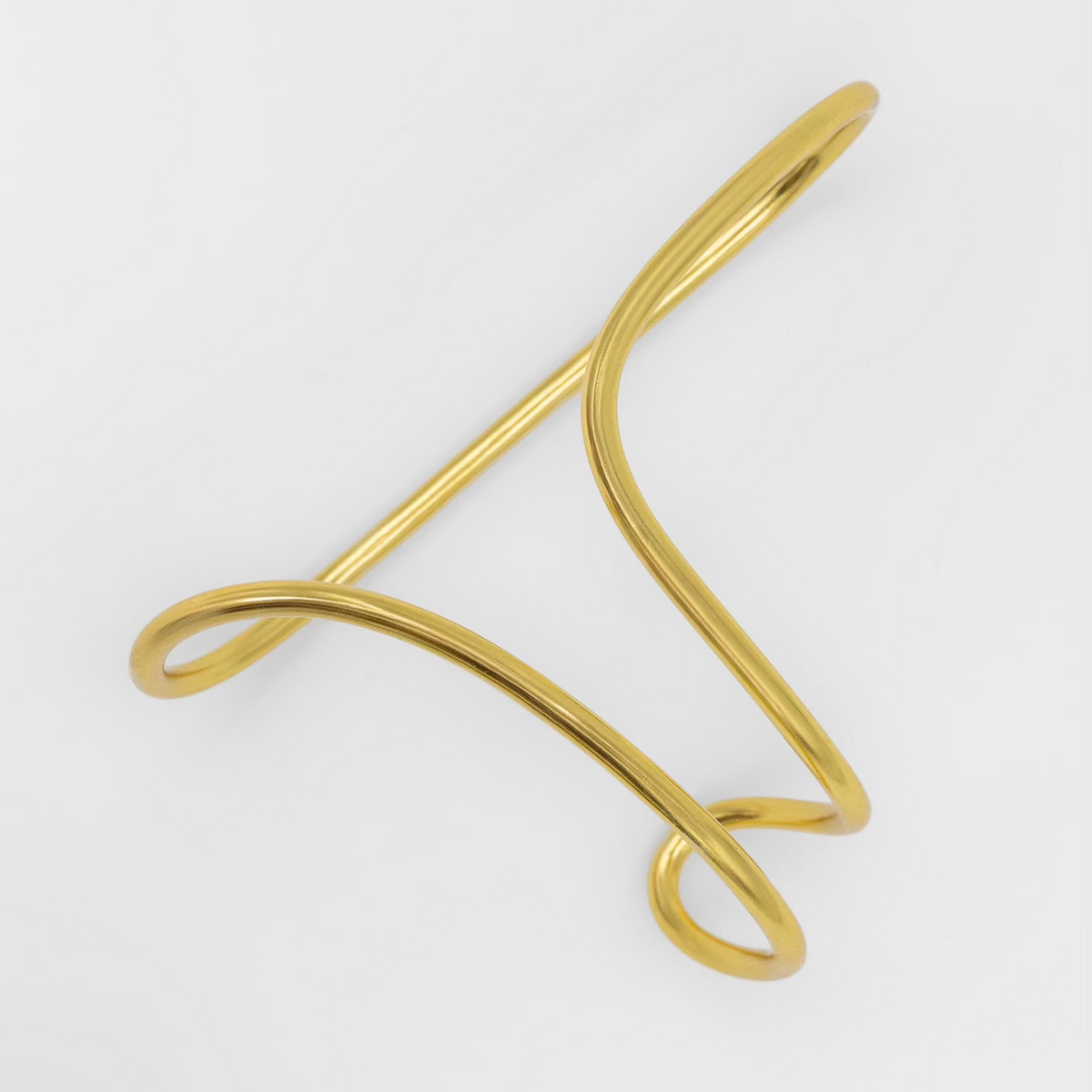 Gold metal bracelet on a white background