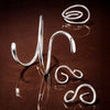Silver jewellery  on a reflective brown surface