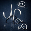 Silver jewellery  on a reflective brown surface